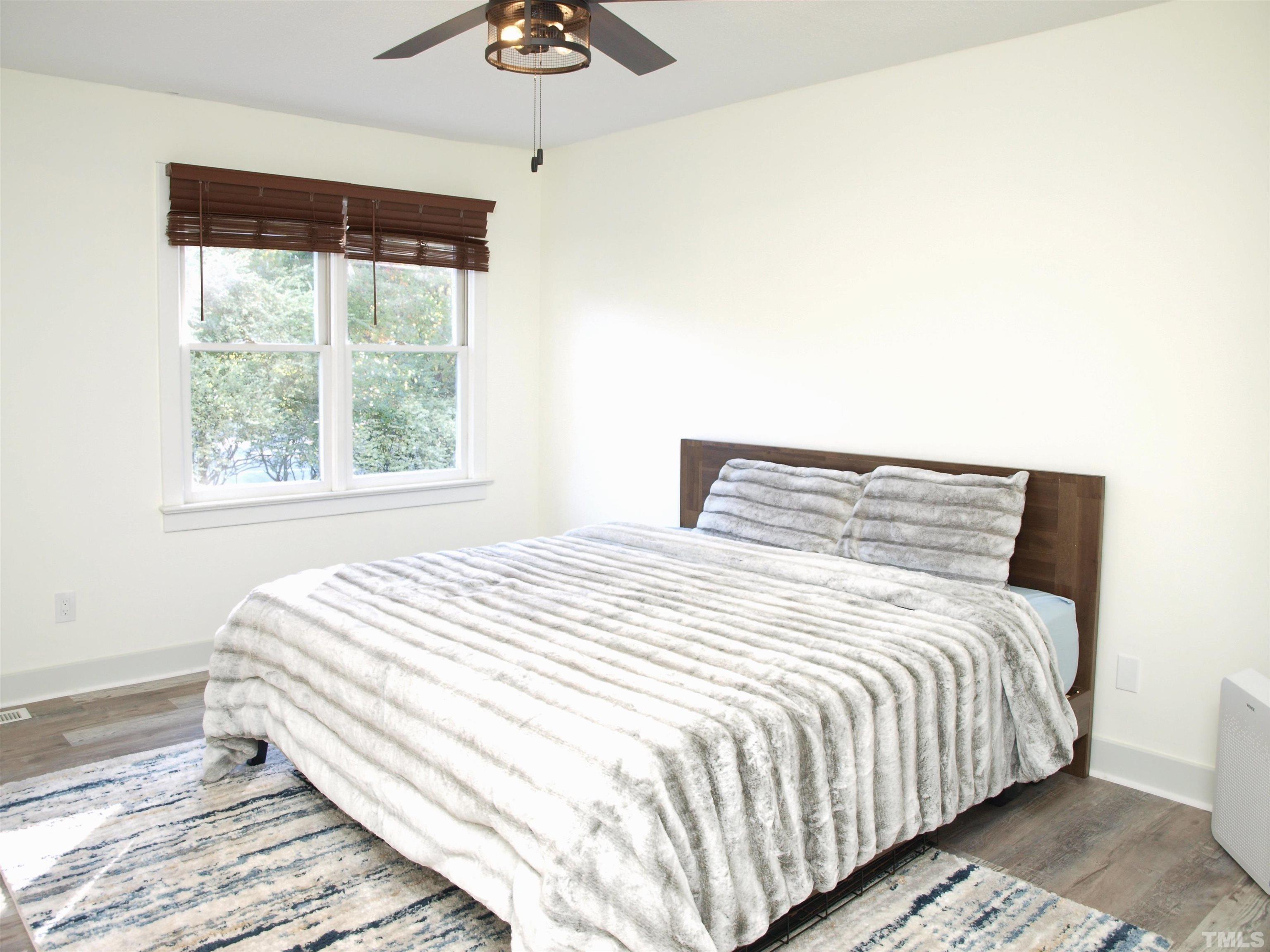 1424 Quarter Point Raleigh, NC 27615 - Photo 11 of 18 a bedroom with a large bed and a window