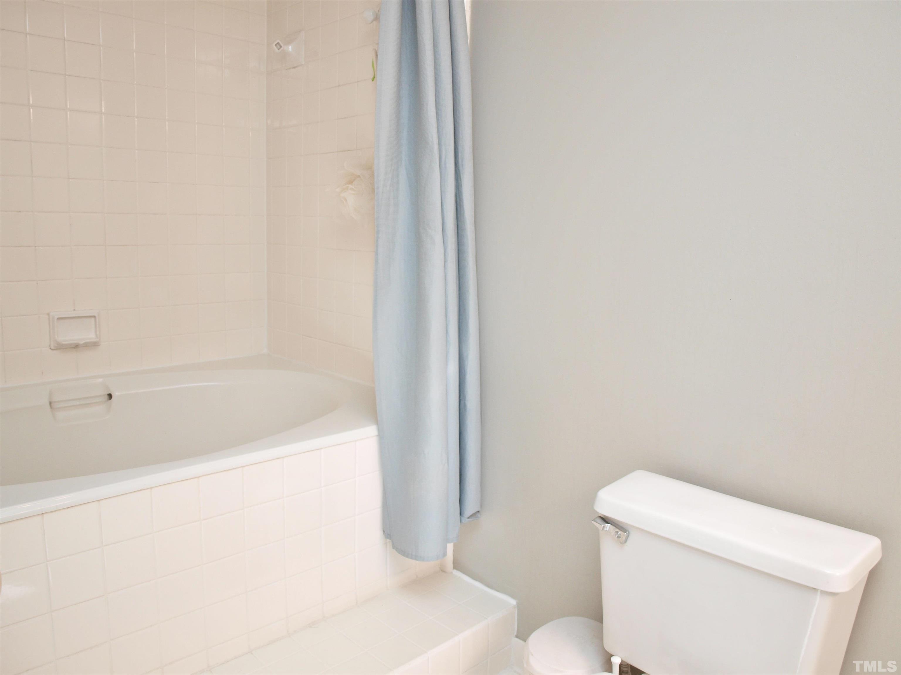 1424 Quarter Point Raleigh, NC 27615 - Photo 13 of 18 a white bath tub sitting next to a toilet