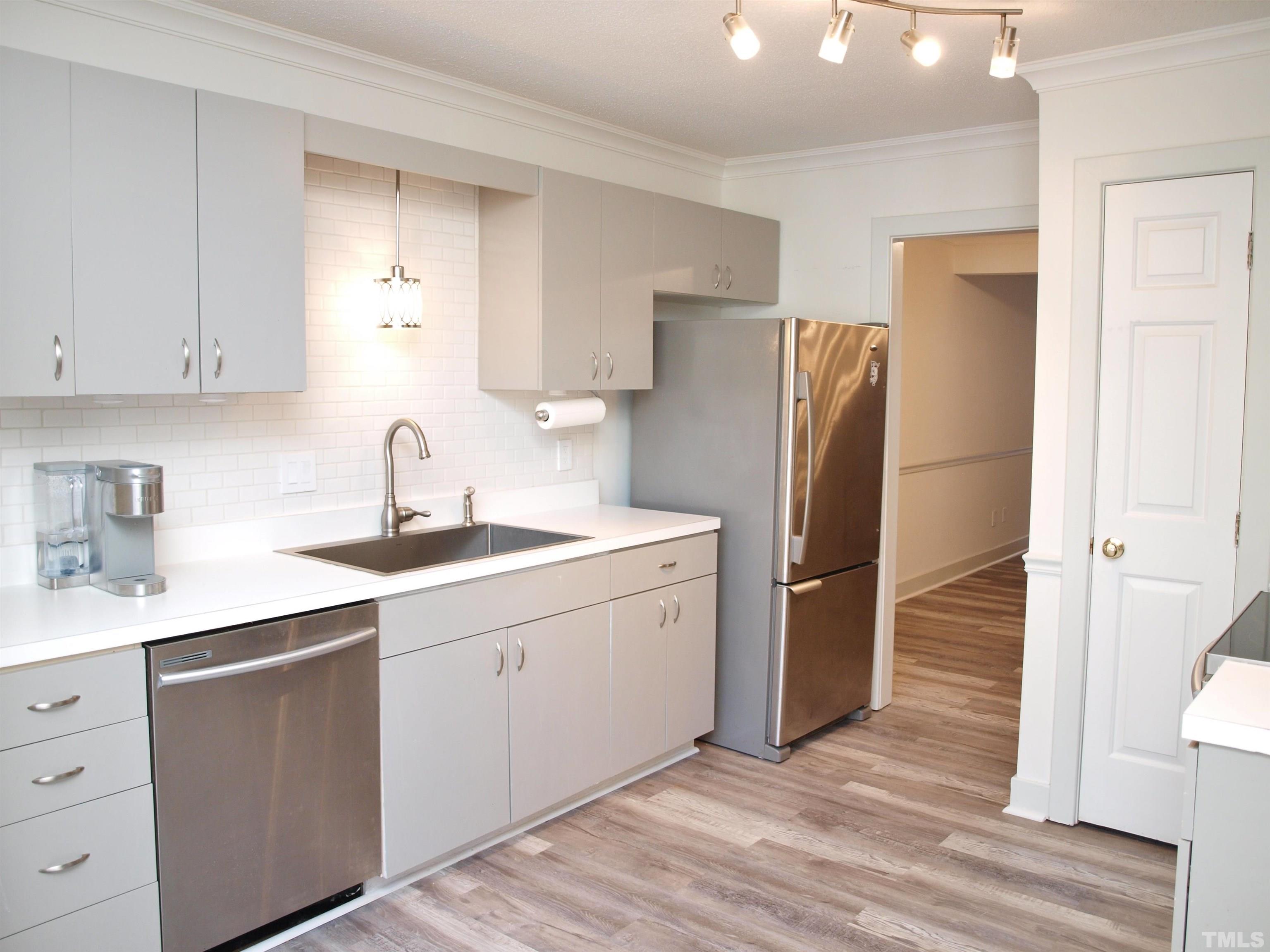 1424 Quarter Point Raleigh, NC 27615 - Photo 2 of 18 a kitchen with a sink cabinets stainless steel appliances and a window