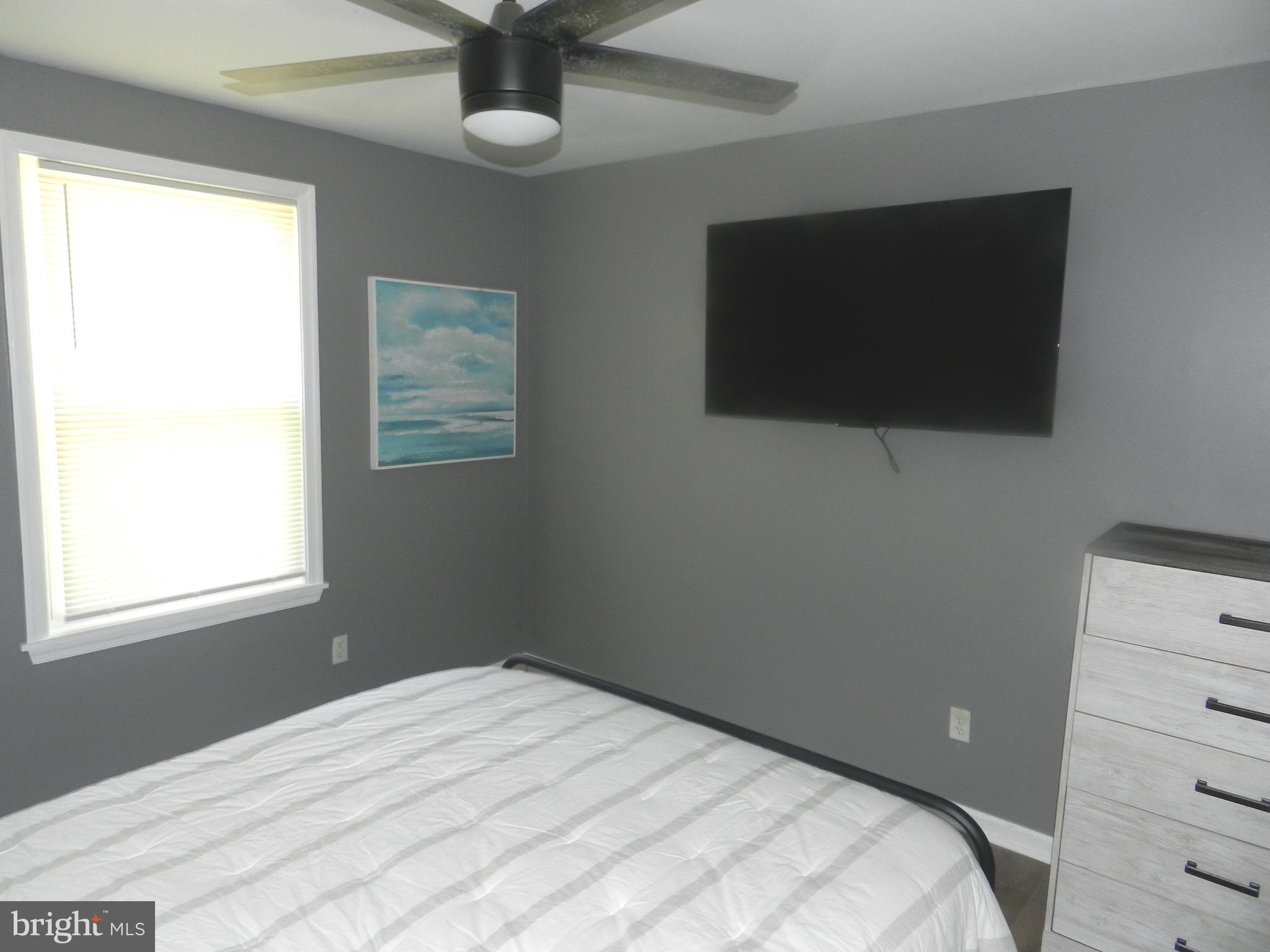 3714 Mayberry Avenue, Unit E Baltimore, MD 21206 - Photo 13 of 28 a bedroom with a bed and a flat tv screen
