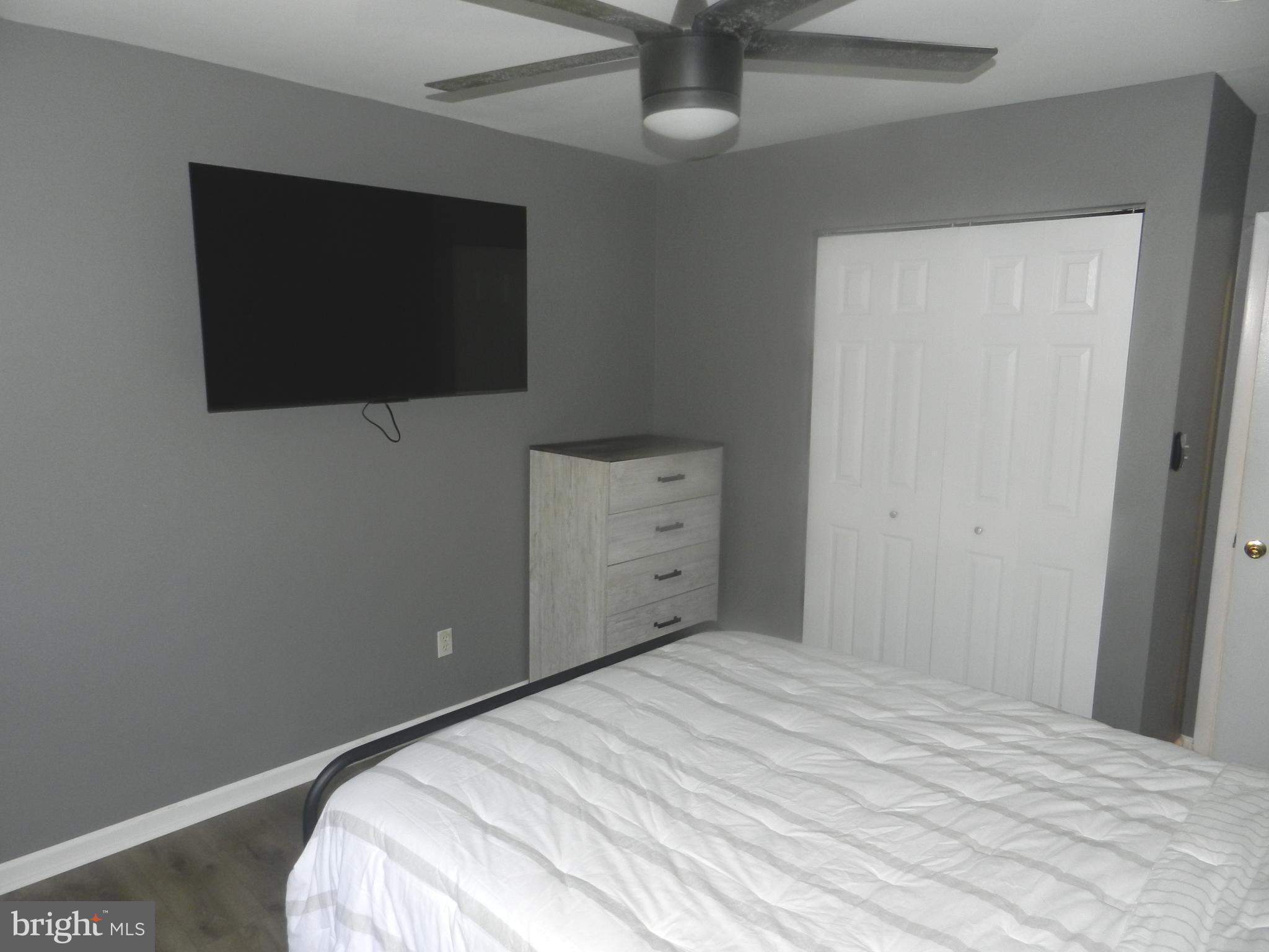 3714 Mayberry Avenue, Unit E Baltimore, MD 21206 - Photo 14 of 28 a bedroom with a bed and a flat screen tv