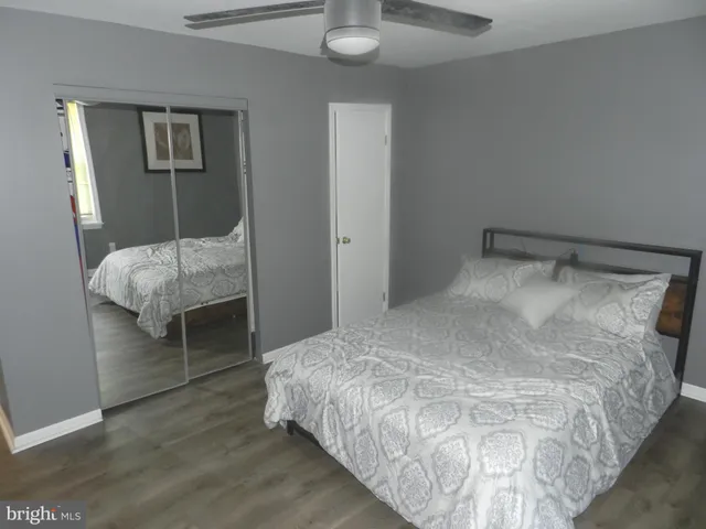 a bedroom with a bed and a mirror