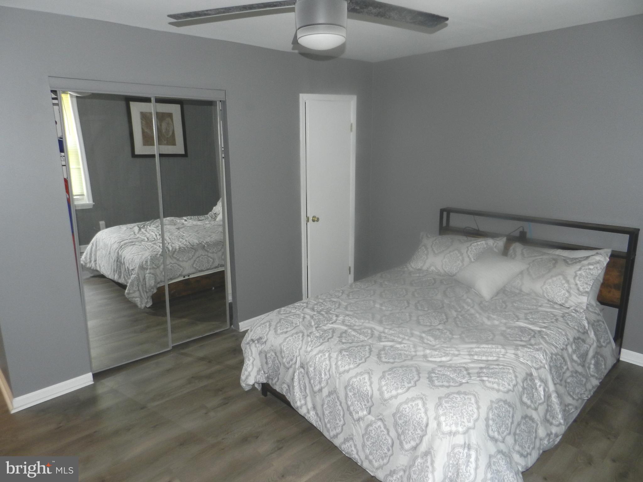 3714 Mayberry Avenue, Unit E Baltimore, MD 21206 - Photo 16 of 28 a bedroom with a bed and a mirror