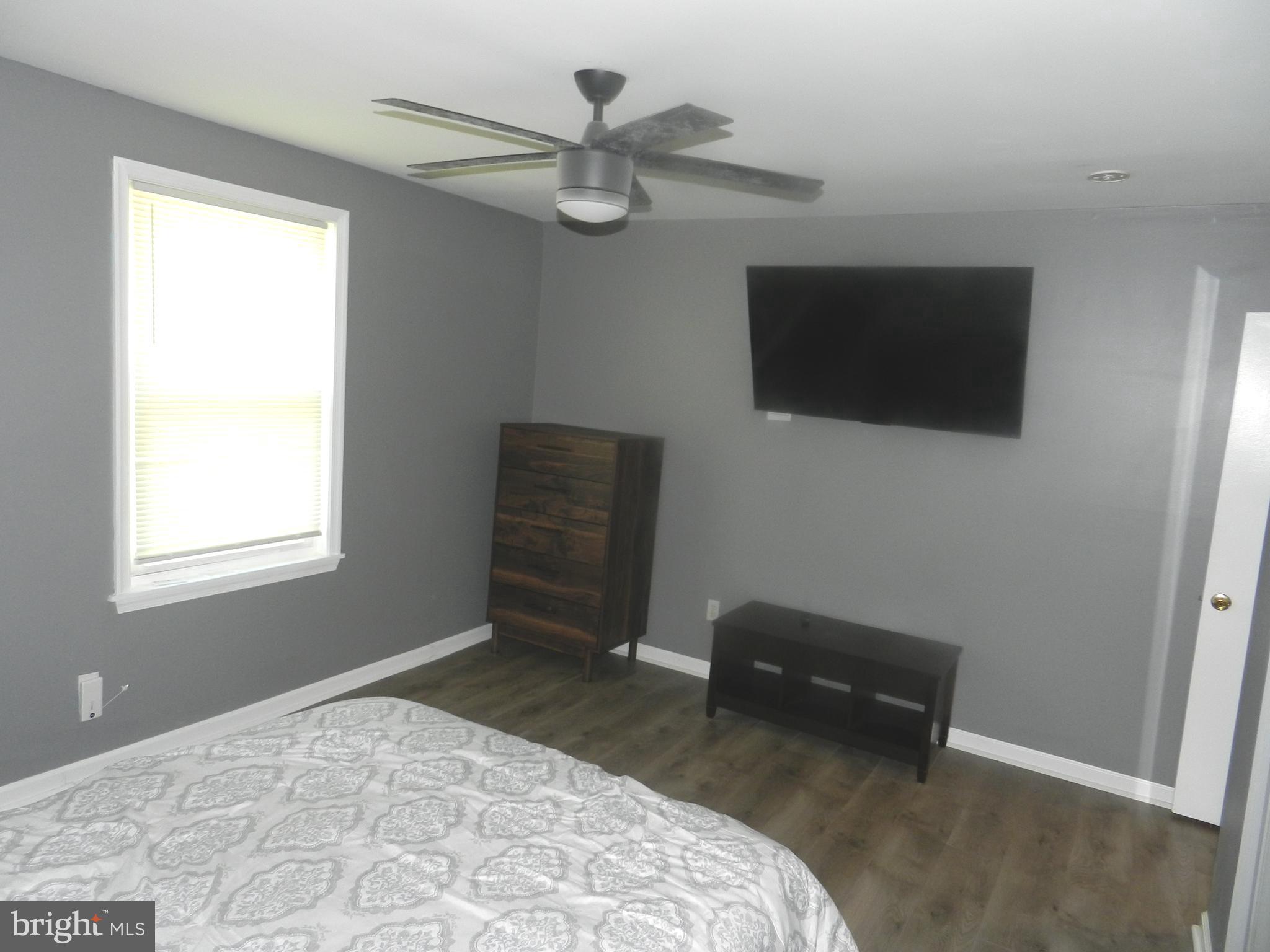 3714 Mayberry Avenue, Unit E Baltimore, MD 21206 - Photo 17 of 28 a bedroom with a bed and a flat screen tv