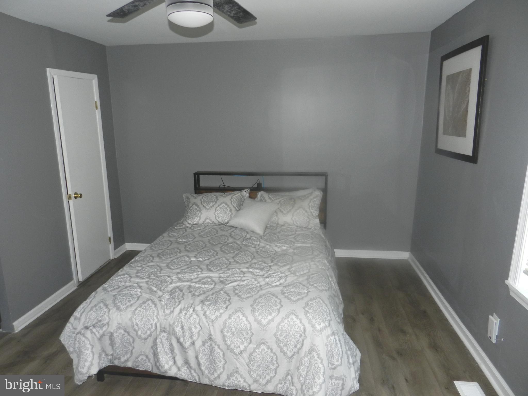 3714 Mayberry Avenue, Unit E Baltimore, MD 21206 - Photo 19 of 28 a bed sitting in a bedroom next to a window