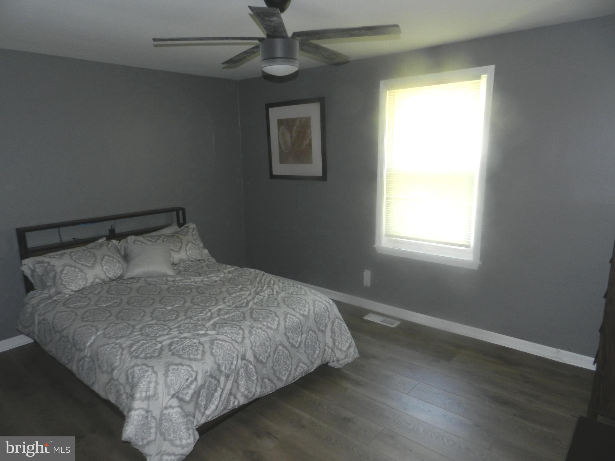 3714 Mayberry Avenue, Unit E Baltimore, MD 21206 - Photo 20 of 28 a bed sitting in a bedroom next to a window