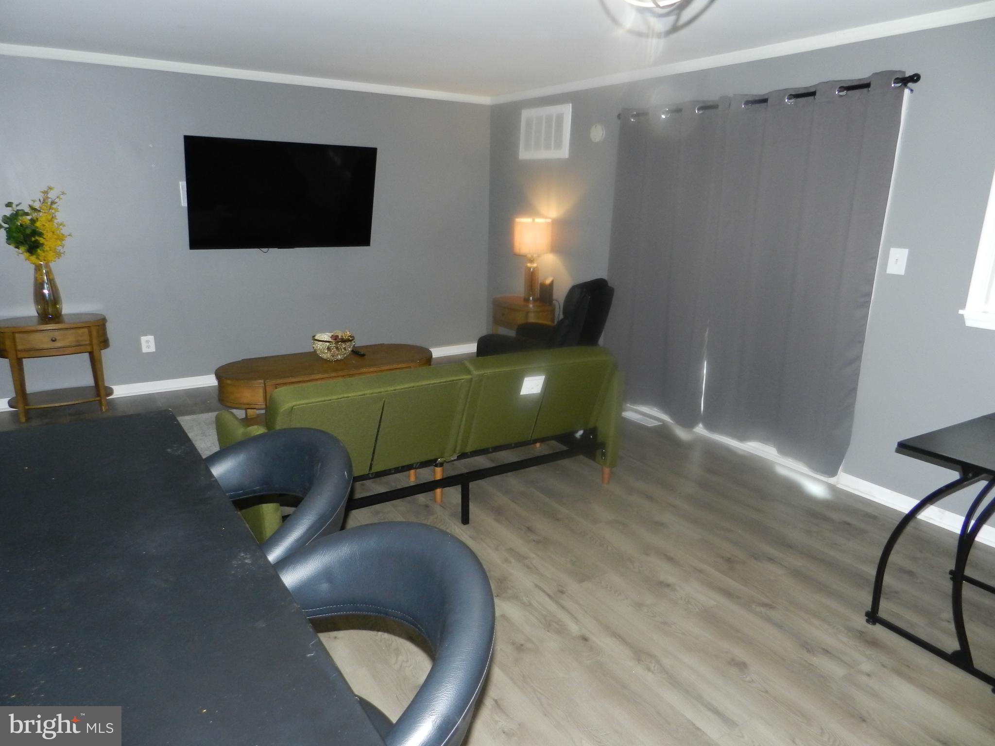 3714 Mayberry Avenue, Unit E Baltimore, MD 21206 - Photo 7 of 28 a living room with furniture and a flat screen tv