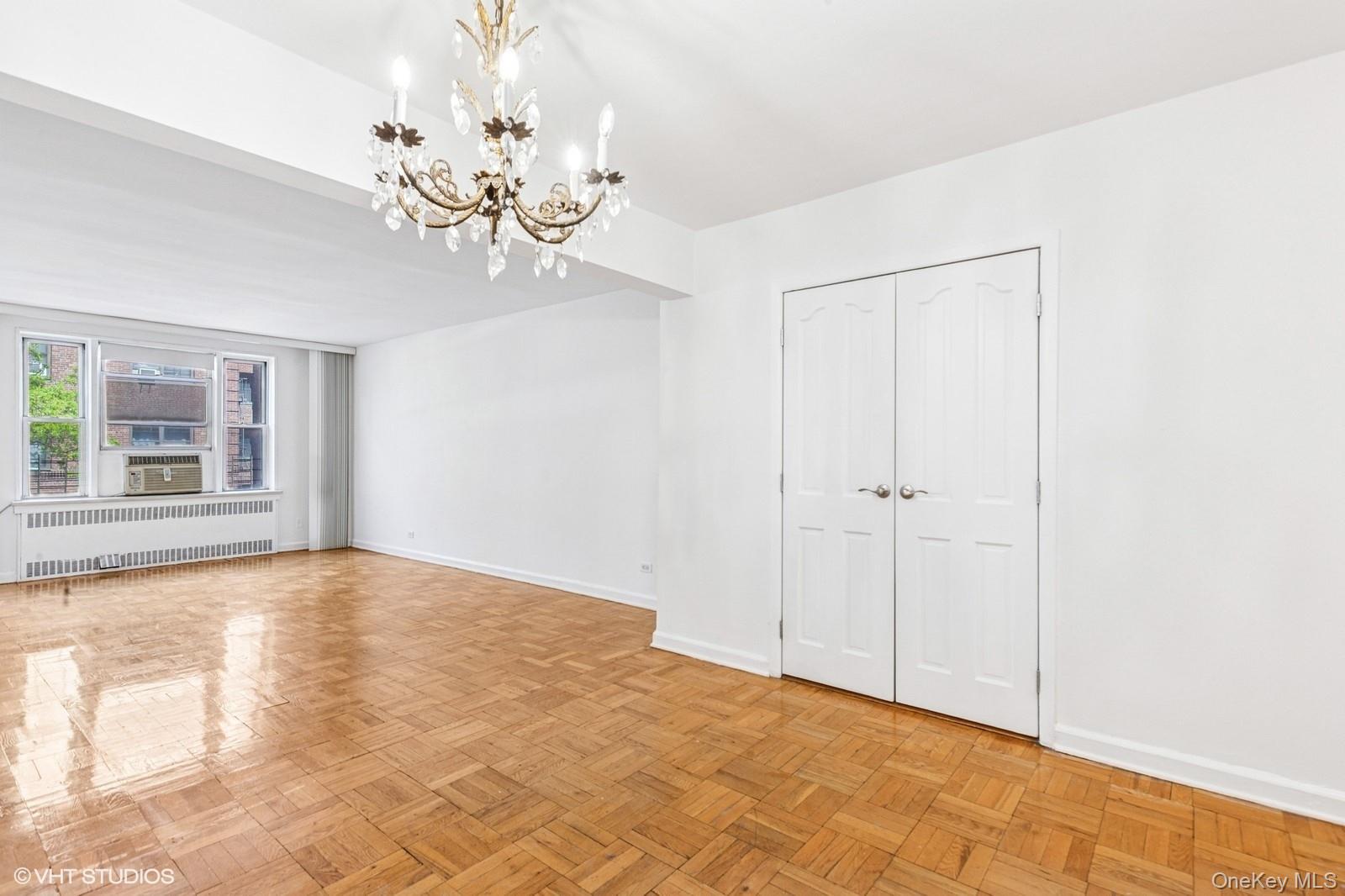 104-20 68th Drive, Unit B19 Queens, NY 11375 - Photo 1 of 15 a view of an empty room with a window