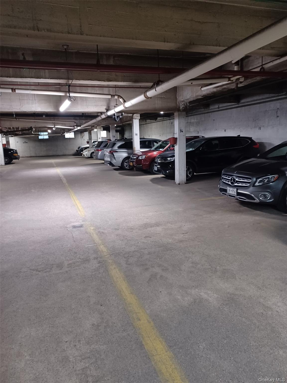 104-20 68th Drive, Unit B19 Queens, NY 11375 - Photo 13 of 15 a view of parking garage with cars