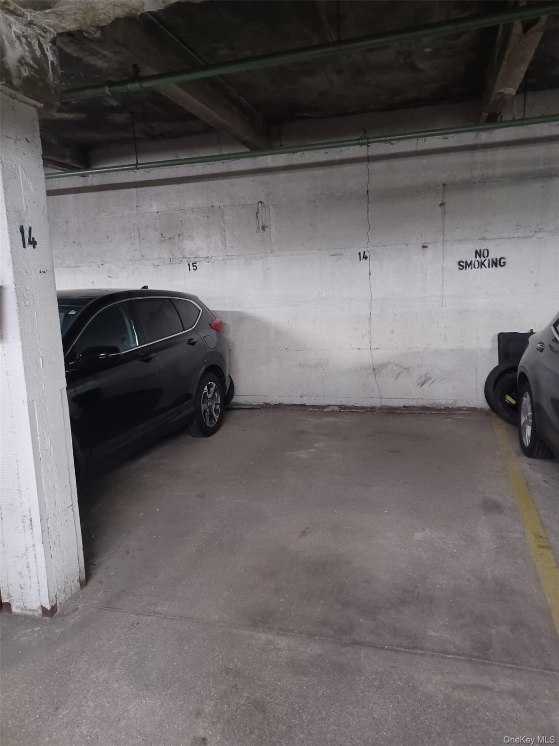 104-20 68th Drive, Unit B19 Queens, NY 11375 - Photo 14 of 15 a car parked in garage