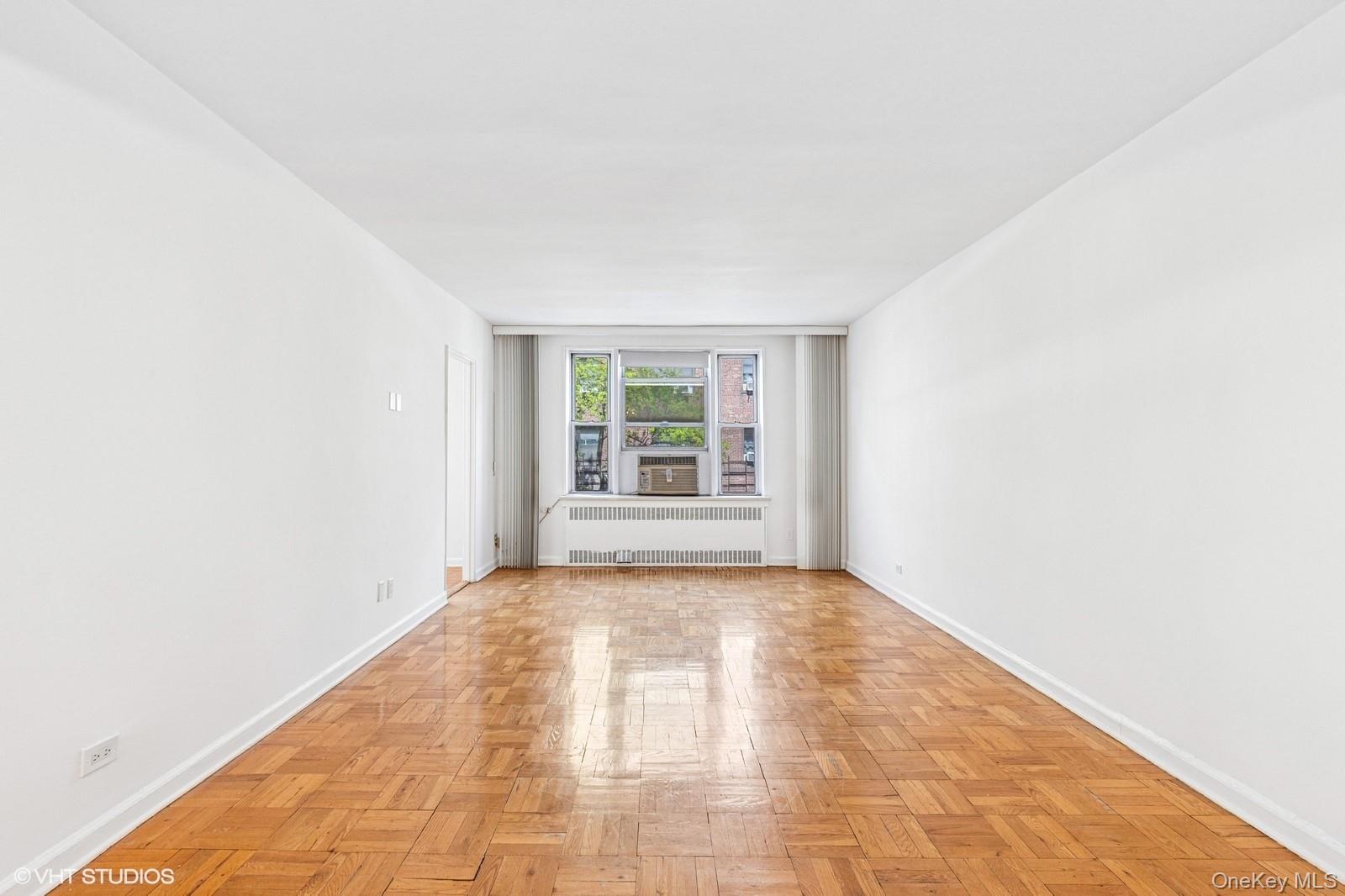 104-20 68th Drive, Unit B19 Queens, NY 11375 - Photo 3 of 15 a view of an empty room and window