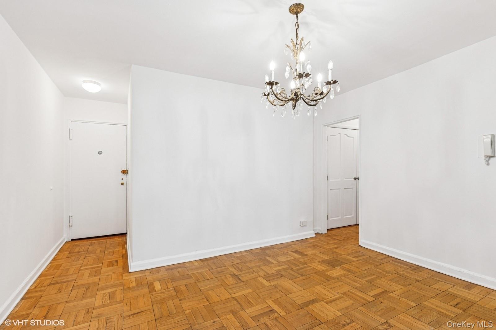 104-20 68th Drive, Unit B19 Queens, NY 11375 - Photo 4 of 15 a view of a chandelier in a room