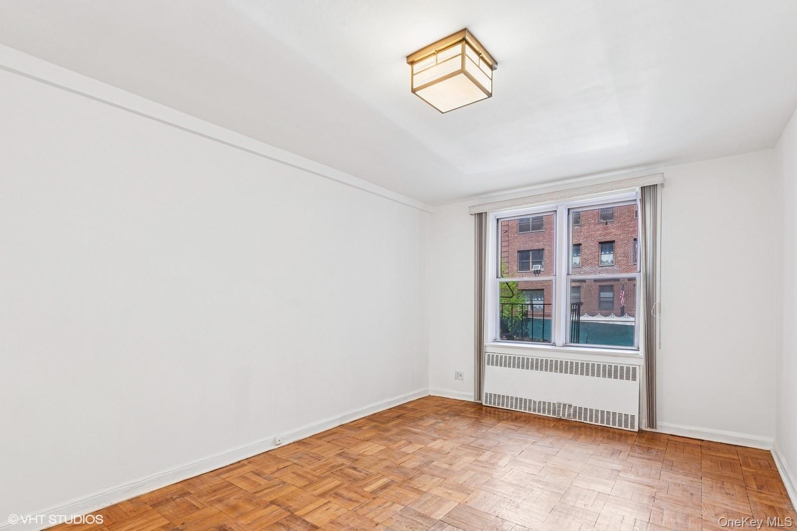 104-20 68th Drive, Unit B19 Queens, NY 11375 - Photo 5 of 15 a view of an empty room with a window
