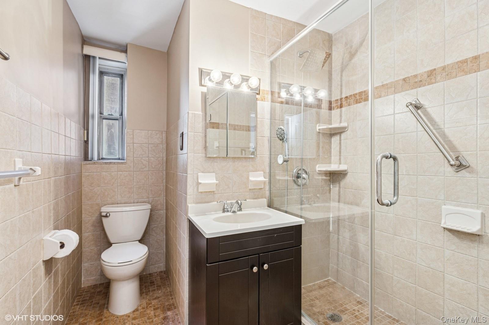 104-20 68th Drive, Unit B19 Queens, NY 11375 - Photo 8 of 15 a bathroom with a toilet sink and shower