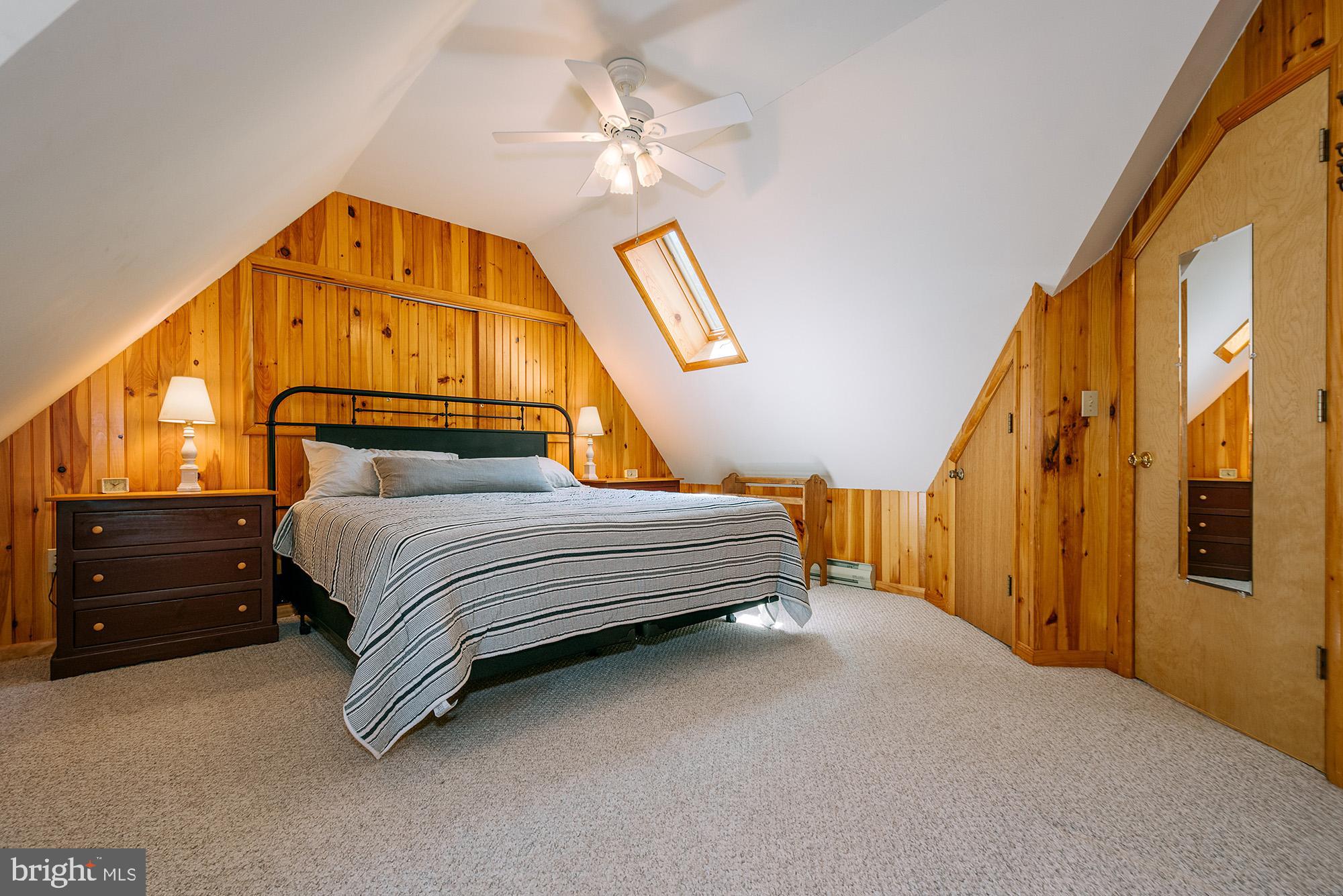 1723 Marsh Hill Road McHenry, MD 21541 - Photo 14 of 40 a bedroom with a bed and a chandelier