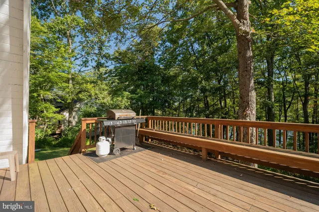 a view of balcony with wooden floor and outdoor seating