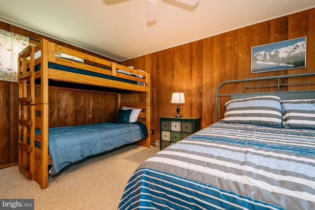 a bedroom with two beds and painted walls