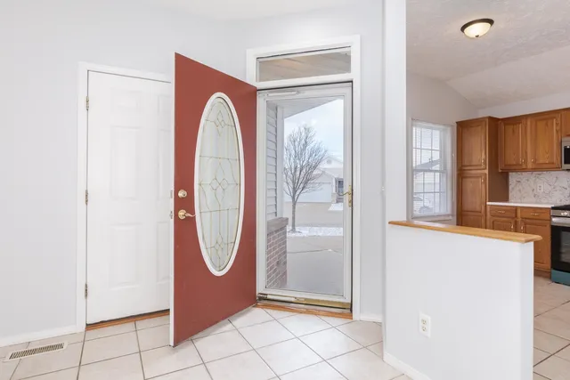 a view of front door with washer and dryer