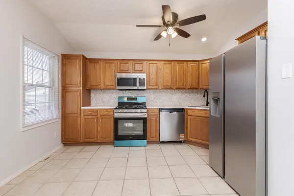 a kitchen with a refrigerator a sink and cabinets