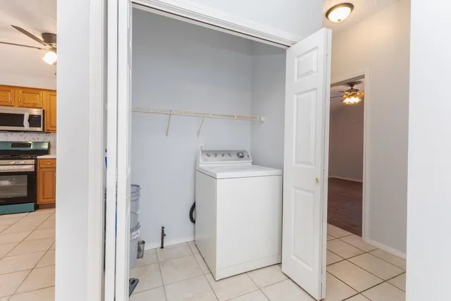 a utility room with cabinets washer and dryer