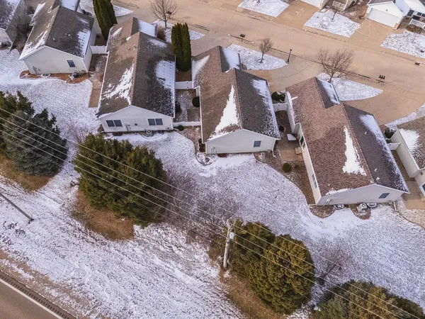 an aerial view of a house with a yard