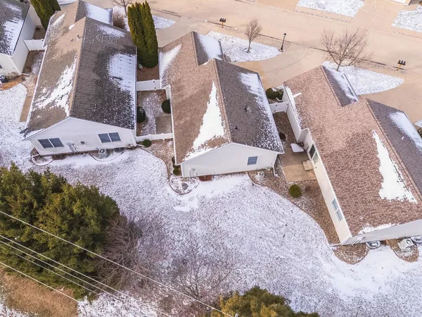 an aerial view of a house with a yard and wooden fence