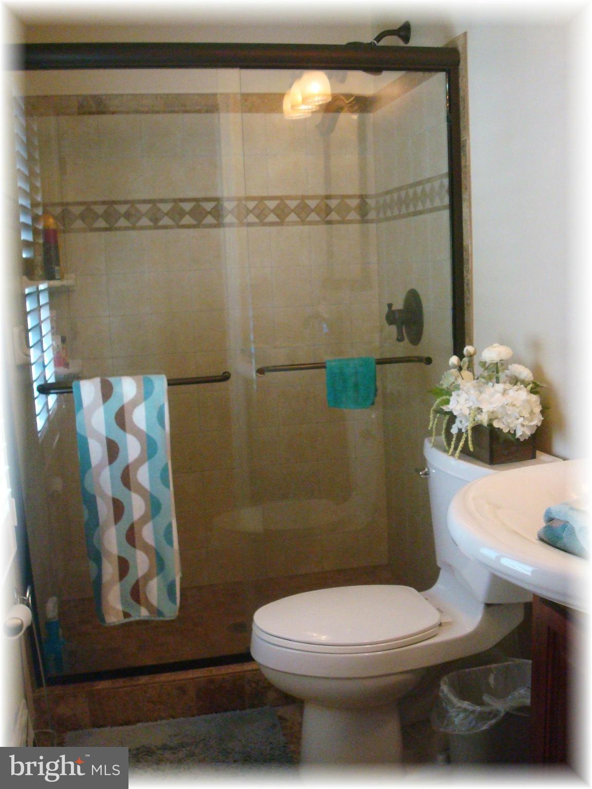 9010 Throgmorton Road Baltimore, MD 21234 - Photo 18 of 30 Renovated master bath with Tuscany tile shower.