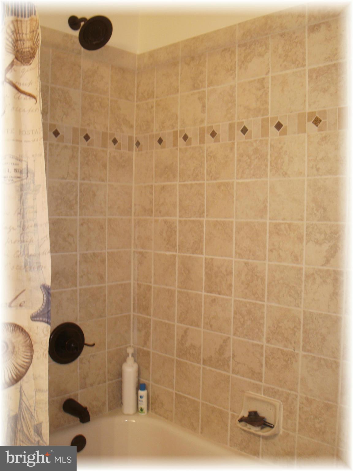 9010 Throgmorton Road Baltimore, MD 21234 - Photo 22 of 30 Main hall bath w/ Tuscany tile shower.