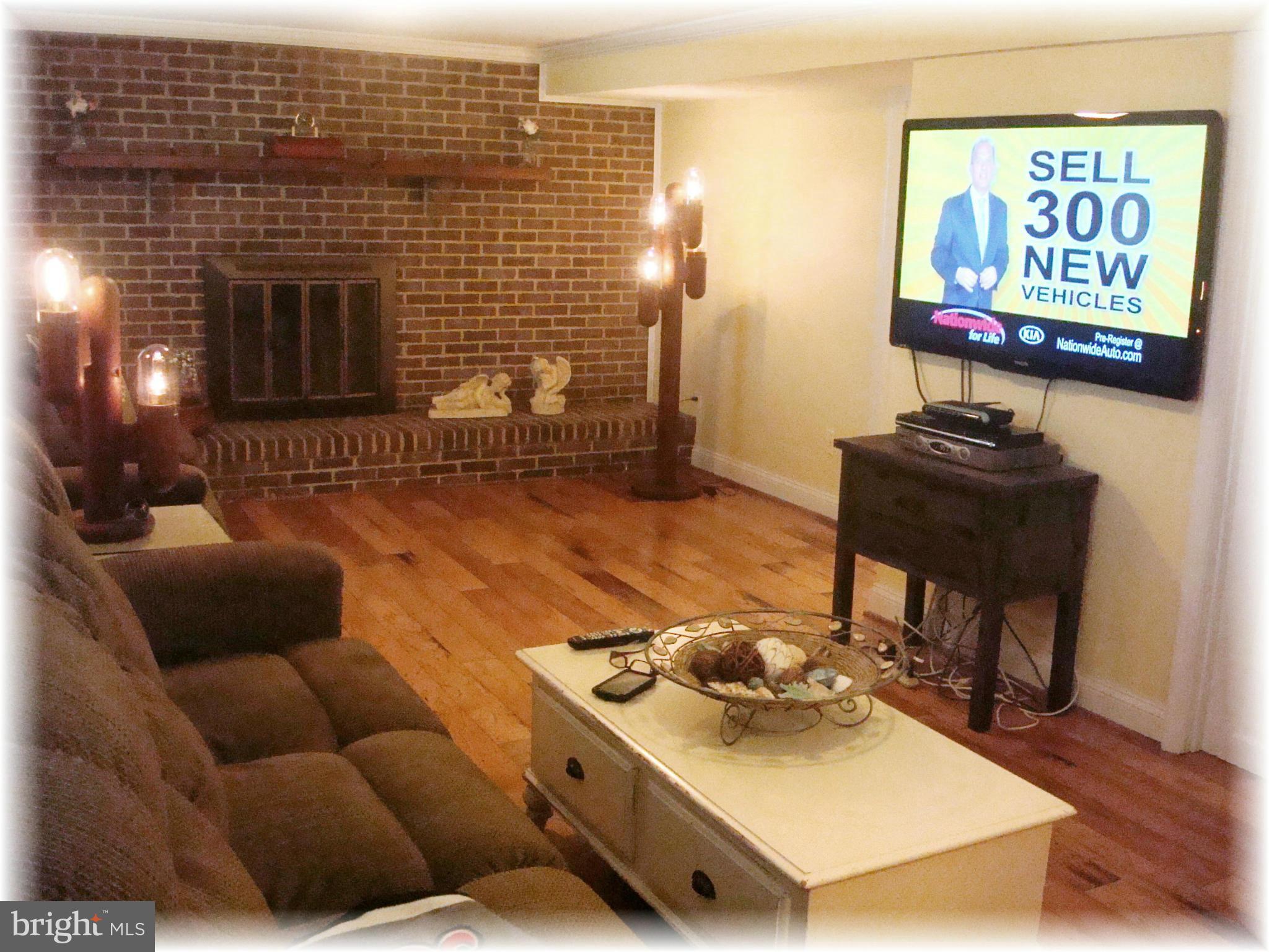 9010 Throgmorton Road Baltimore, MD 21234 - Photo 24 of 30 Family Rm w/ brick, wood-burning fireplace.