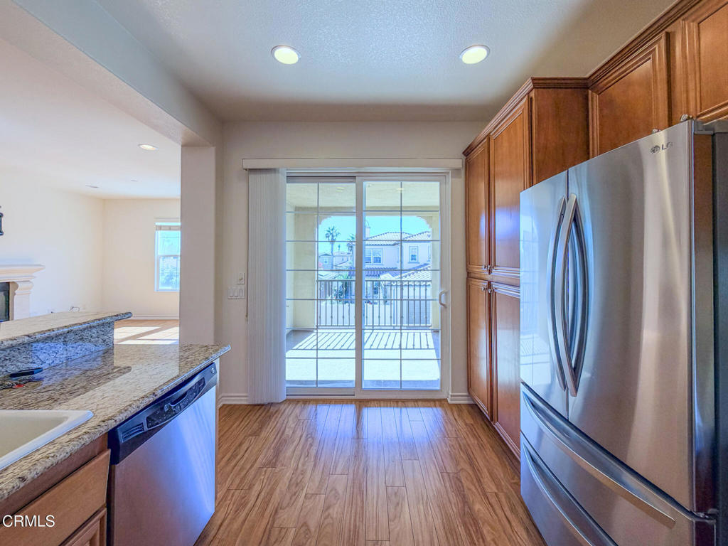 8262 Onyx Street Ventura, CA 93004 - Photo 11 of 33 a kitchen with stainless steel appliances granite countertop a refrigerator and a sink