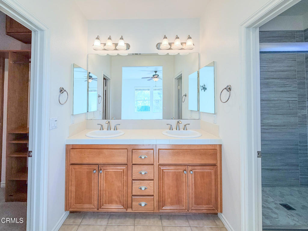 8262 Onyx Street Ventura, CA 93004 - Photo 17 of 33 a bathroom with a double vanity sink and a mirror