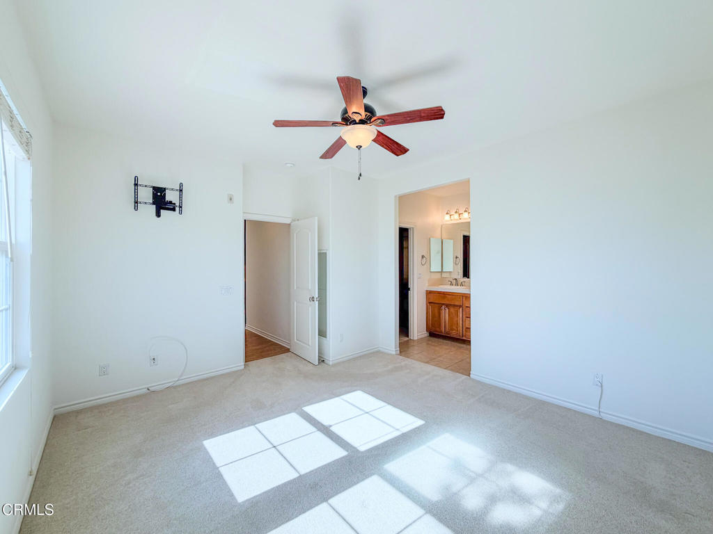 8262 Onyx Street Ventura, CA 93004 - Photo 18 of 33 a view of a room with a ceiling fan and window