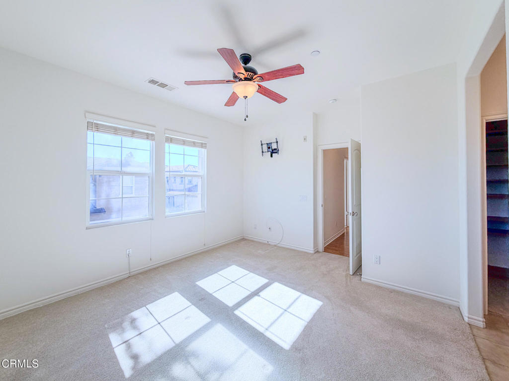 8262 Onyx Street Ventura, CA 93004 - Photo 19 of 33 an empty room with windows and fan