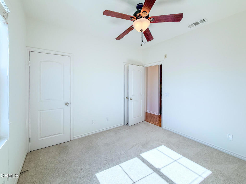 8262 Onyx Street Ventura, CA 93004 - Photo 24 of 33 an empty room with closet and a chandelier fan