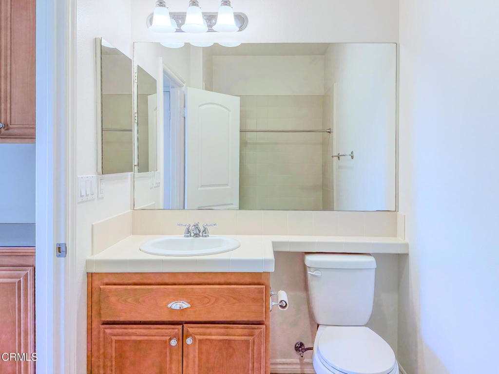 8262 Onyx Street Ventura, CA 93004 - Photo 26 of 33 a bathroom with a toilet sink and mirror