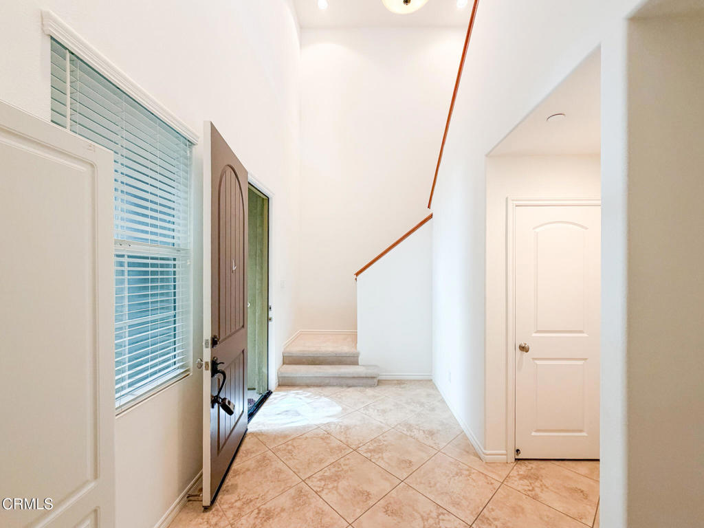 8262 Onyx Street Ventura, CA 93004 - Photo 27 of 33 a view of a hallway with wooden floor and entryway