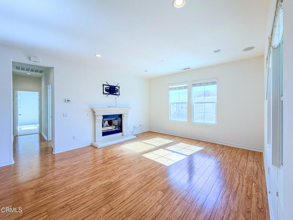 8262 Onyx Street Ventura, CA 93004 - Photo 4 of 33 an empty room with wooden floor and windows