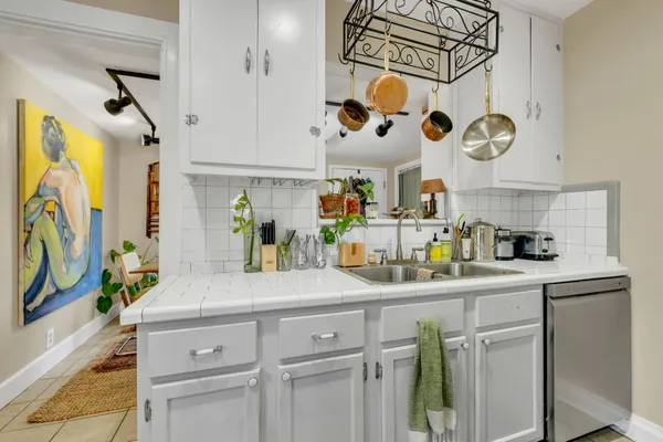 a kitchen with a sink a cabinets and appliances