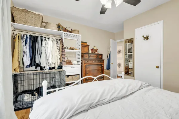 a bedroom with a bed dresser and a window
