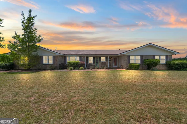 a view of a house with a swimming pool with a yard
