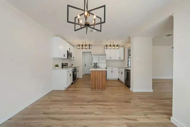 a view of a kitchen with a sink dishwasher and refrigerator