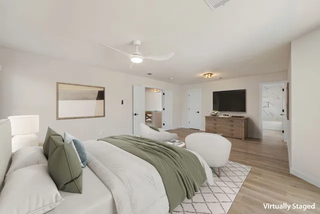 a bedroom with a bed and a television