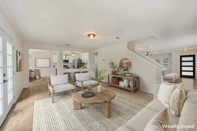 a living room with furniture and a wooden floor