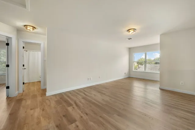wooden floor in an empty room with a window