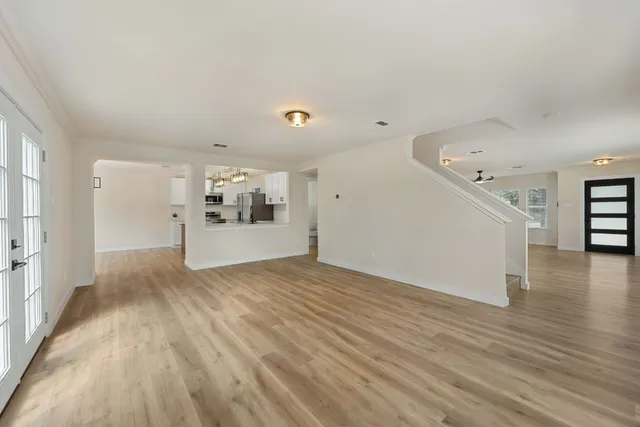 wooden floor in an empty room with a window