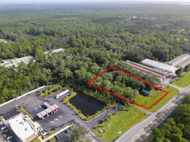 an aerial view of residential houses with outdoor space and swimming pool