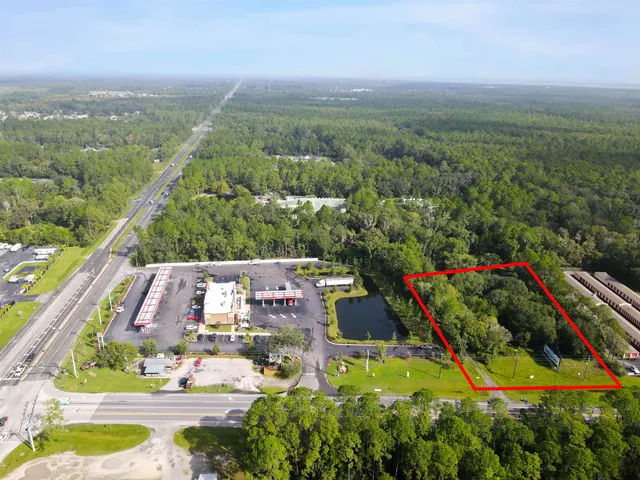 an aerial view of residential houses with outdoor space and swimming pool