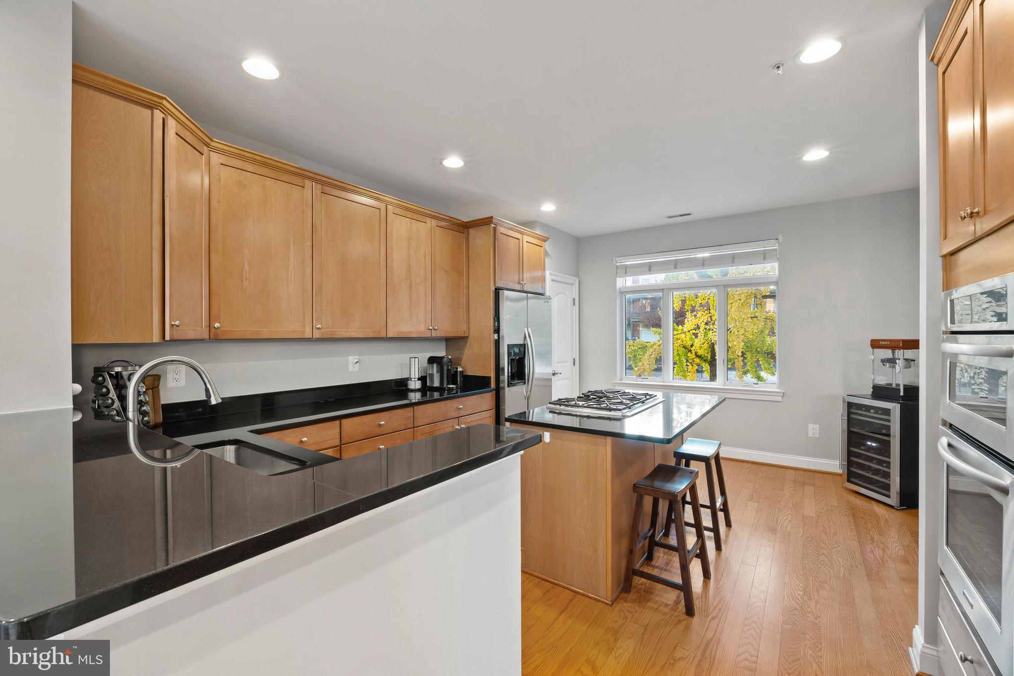 900 Valencia Court, Unit 188 Baltimore, MD 21230 - Photo 19 of 62 a kitchen with stainless steel appliances granite countertop a sink stove and wooden floor