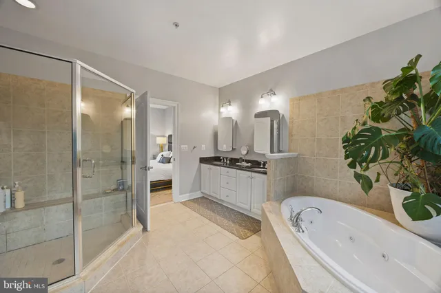 a bathroom with a granite countertop toilet a sink a mirror and a window