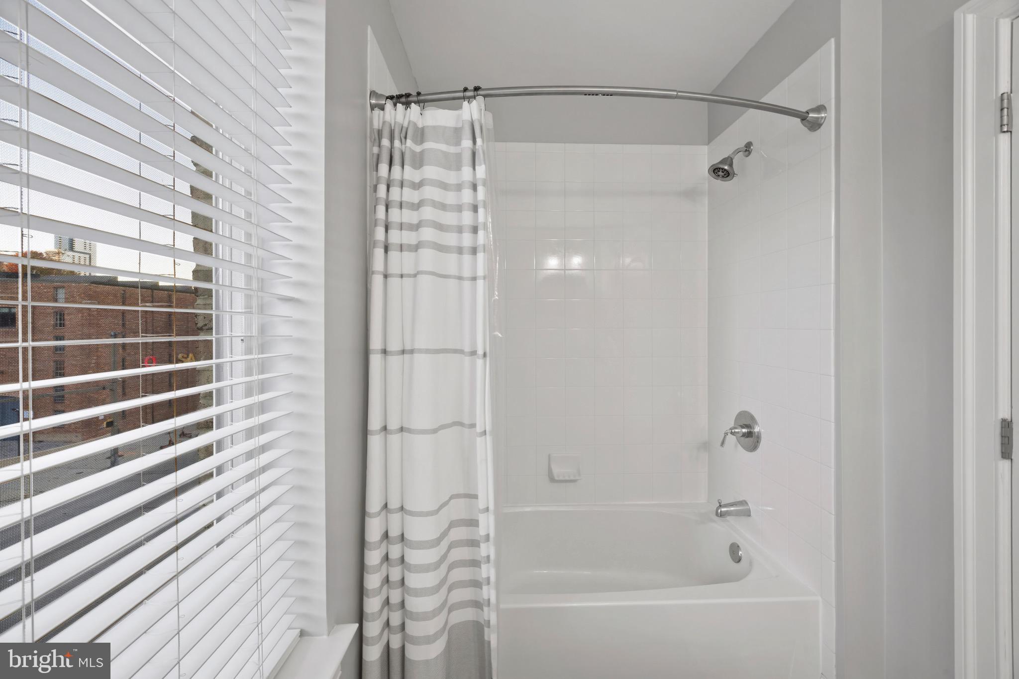 900 Valencia Court, Unit 188 Baltimore, MD 21230 - Photo 44 of 62 a bathroom with a shower and a bath tub